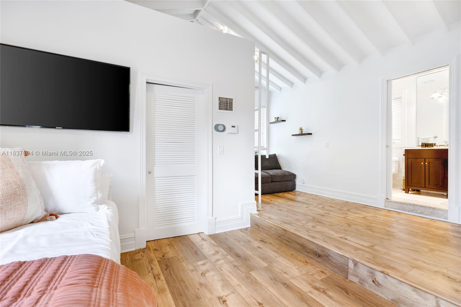 113 Northeast 101st Street Miami Shores, FL 33138 - Photo 37 of 56 a bedroom with a bed and a flat screen tv