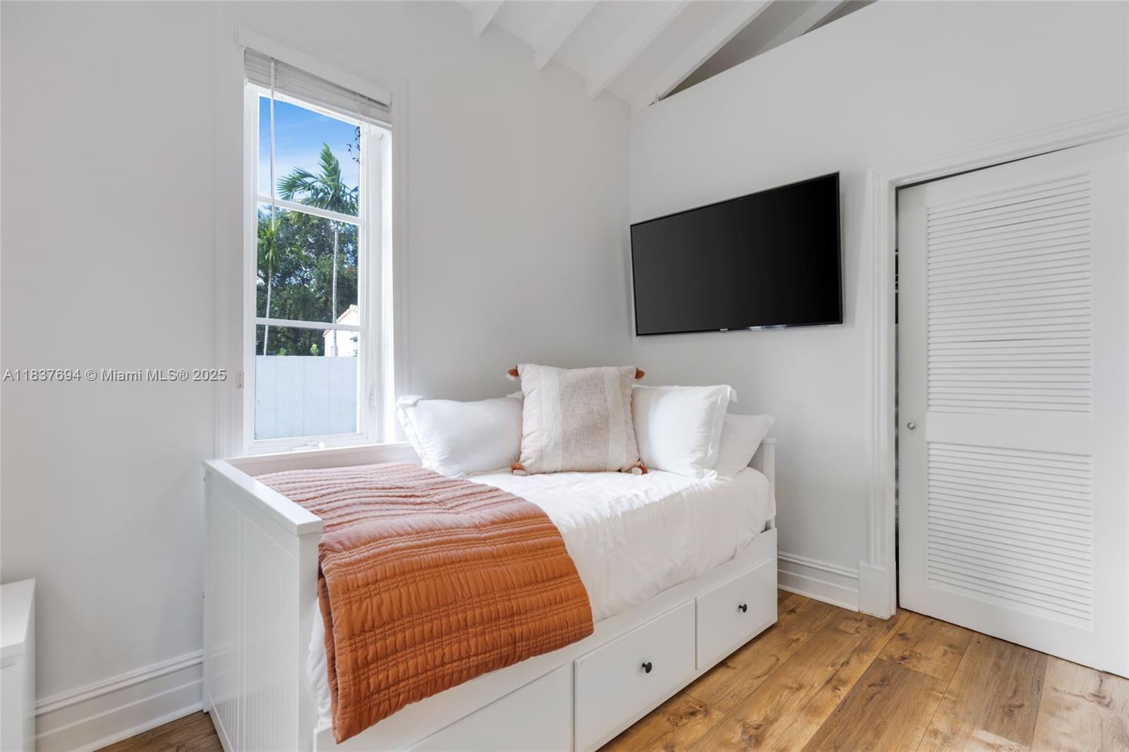 113 Northeast 101st Street Miami Shores, FL 33138 - Photo 38 of 56 a bedroom with a bed and a flat screen tv