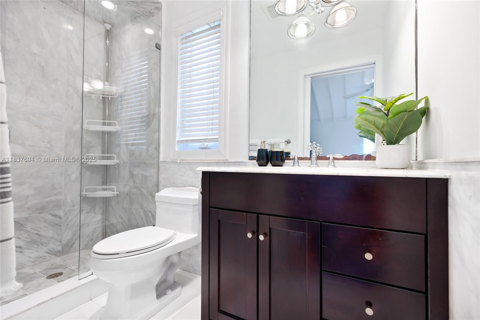 113 Northeast 101st Street Miami Shores, FL 33138 - Photo 40 of 56 a bathroom with a sink a toilet and shower