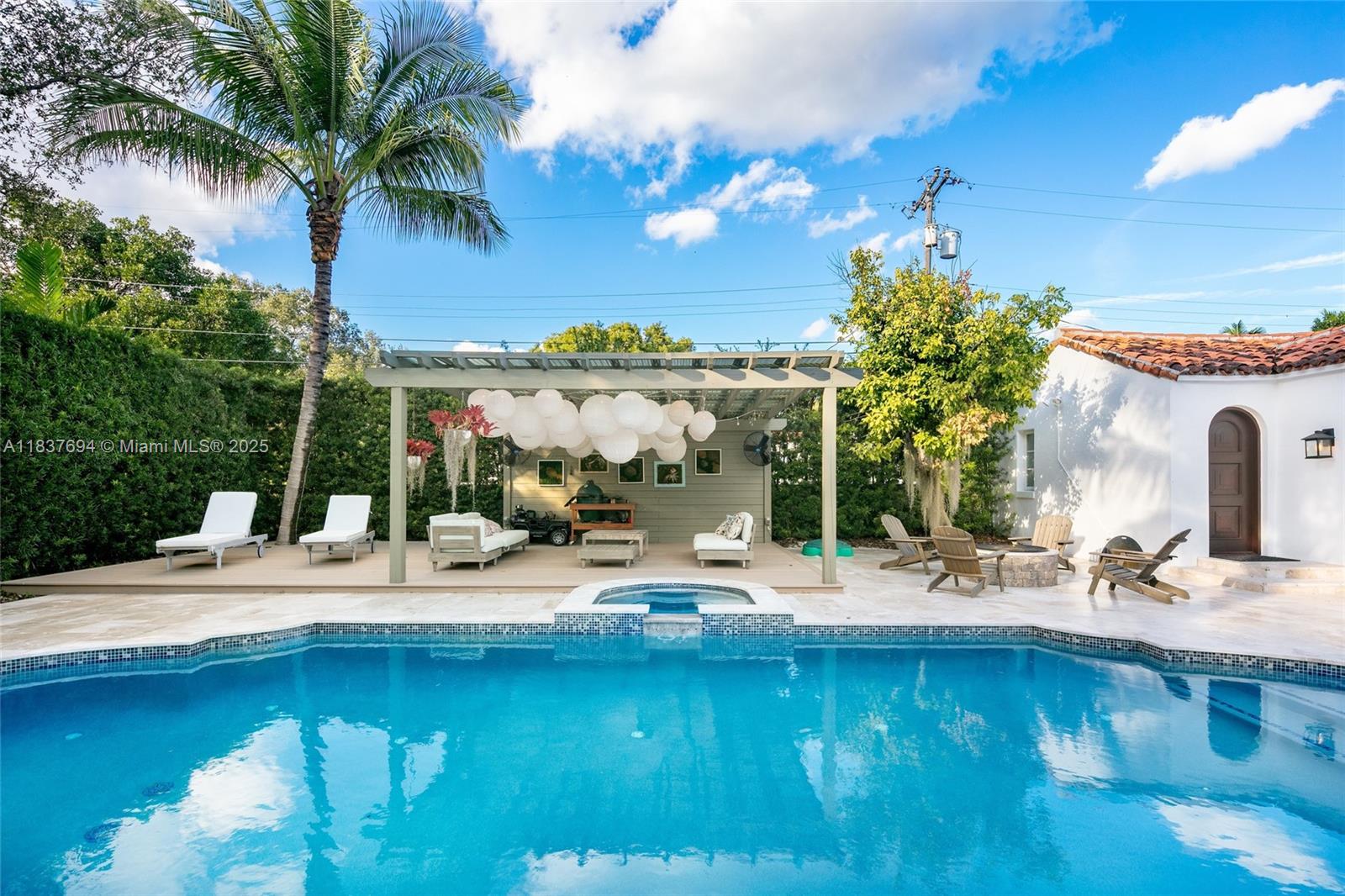 113 Northeast 101st Street Miami Shores, FL 33138 - Photo 43 of 56 a view of a patio with a table and chairs