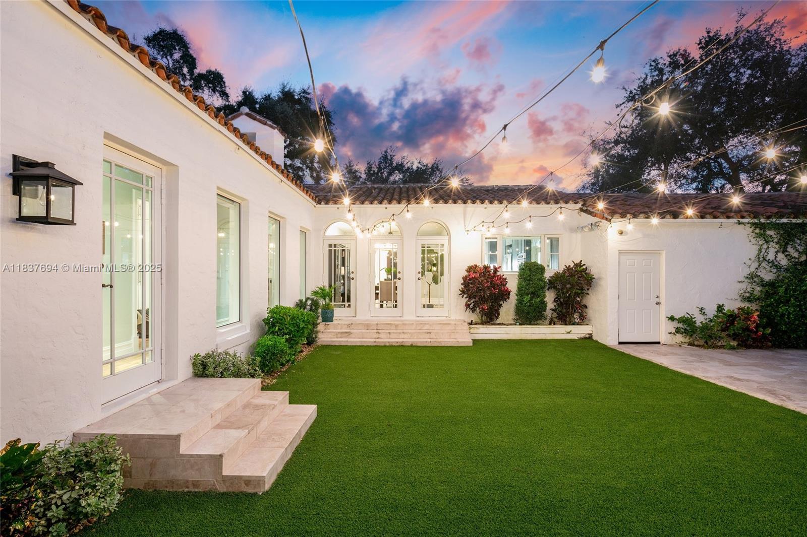 113 Northeast 101st Street Miami Shores, FL 33138 - Photo 48 of 56 a view of a house with a yard and potted plants