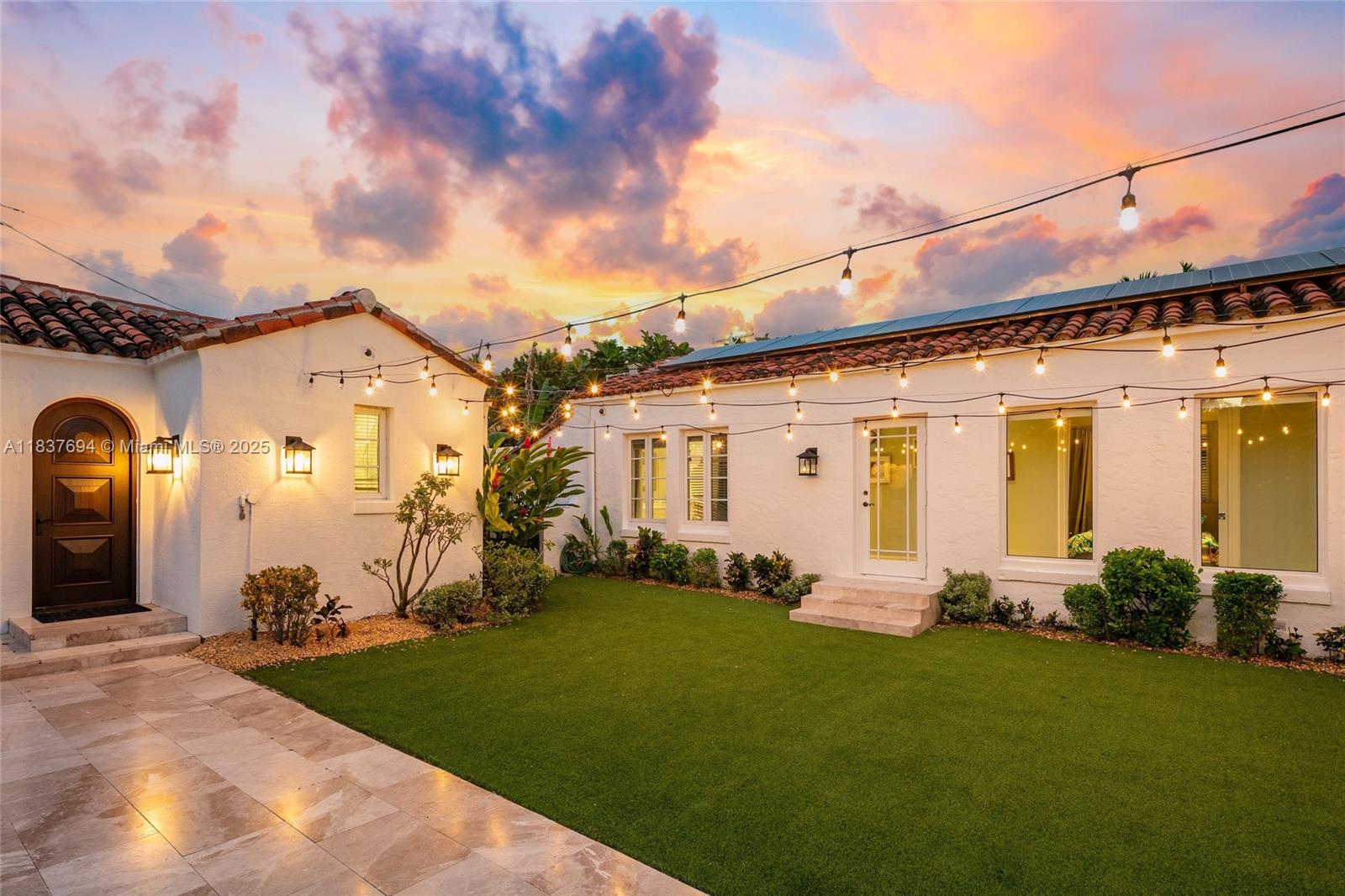 113 Northeast 101st Street Miami Shores, FL 33138 - Photo 50 of 56 a front view of a house with a garden and plants