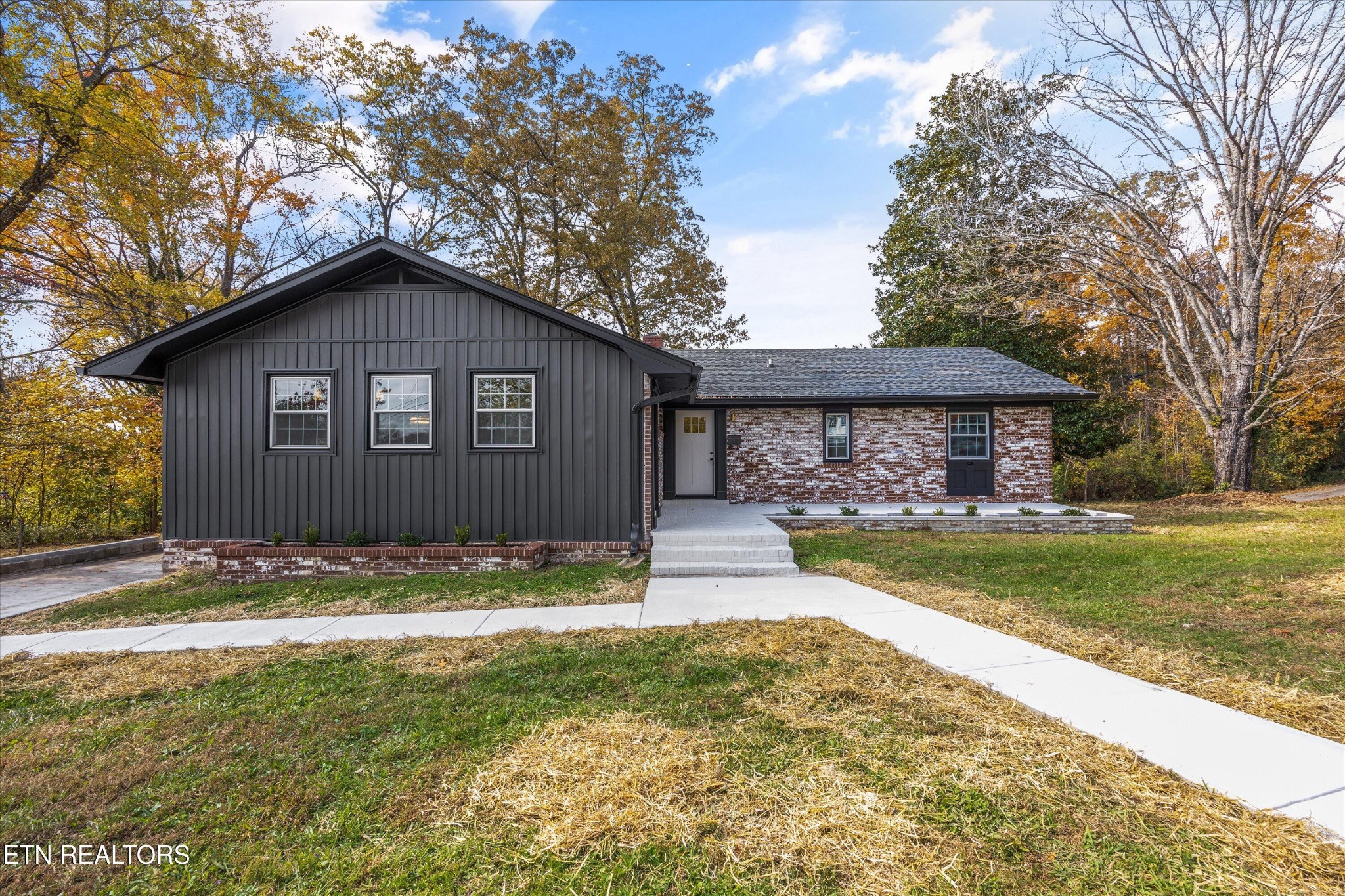 100 Pearl Road Oak Ridge, TN 37830 - Photo 1 of 37 a view of a yard in front of a house with a large tree