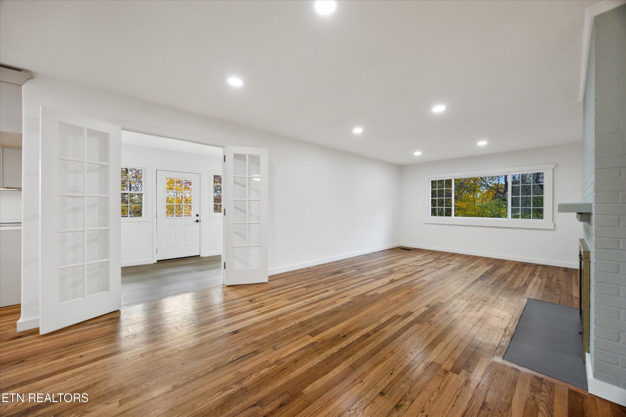 100 Pearl Road Oak Ridge, TN 37830 - Photo 11 of 37 a view of an empty room with wooden floor and a window