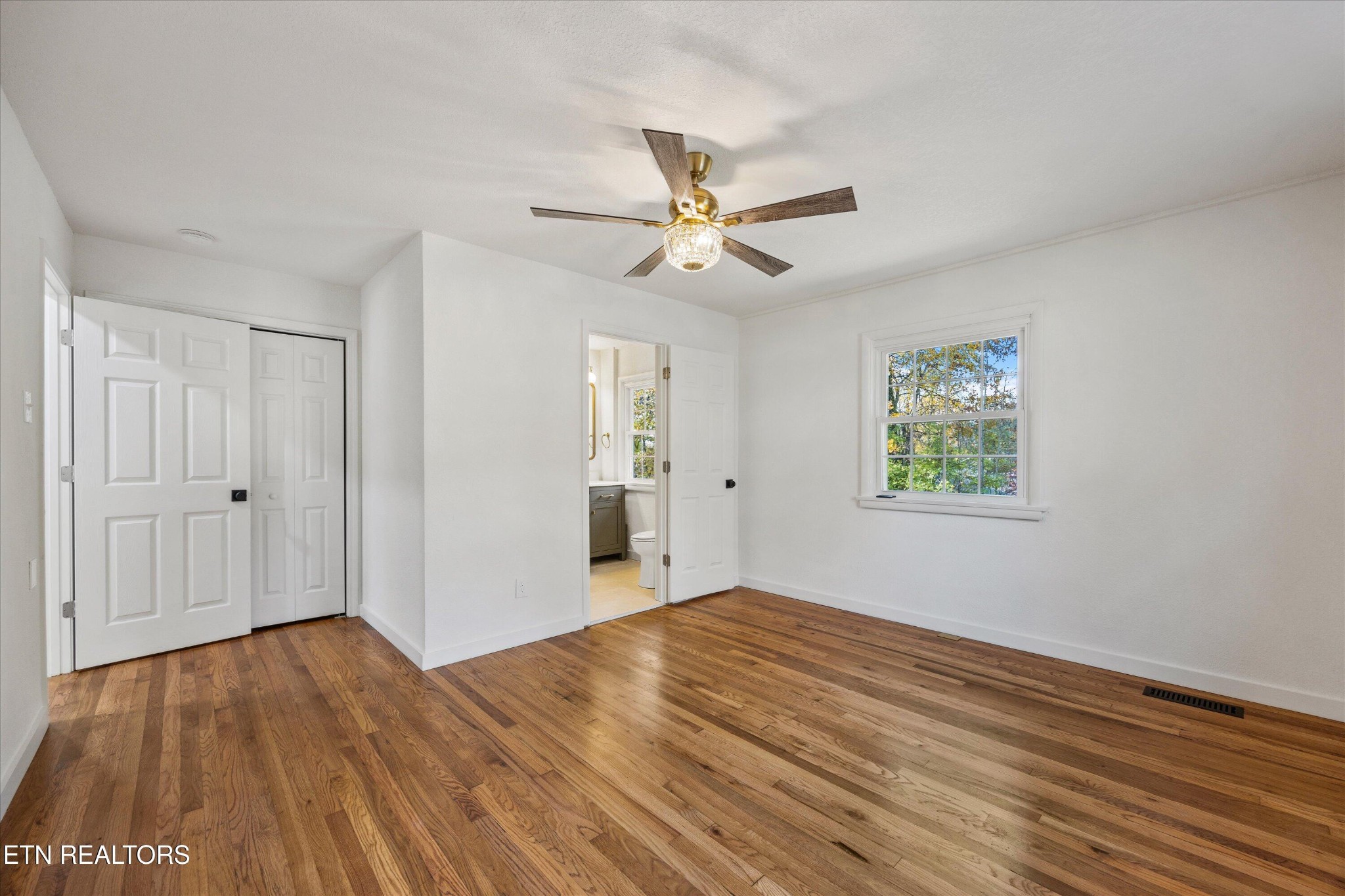 100 Pearl Road Oak Ridge, TN 37830 - Photo 17 of 37 a view of empty room with wooden floor and fan