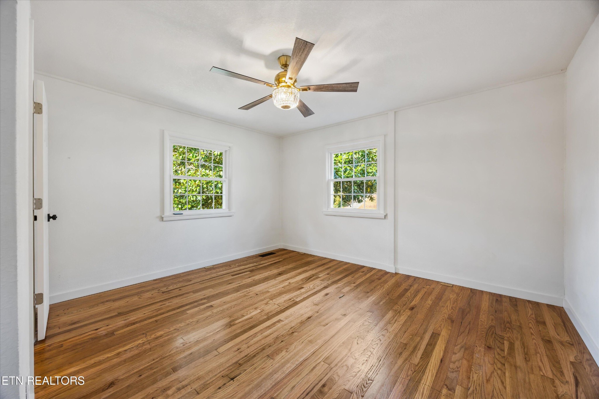 100 Pearl Road Oak Ridge, TN 37830 - Photo 21 of 37 wooden floor in an empty room with a window
