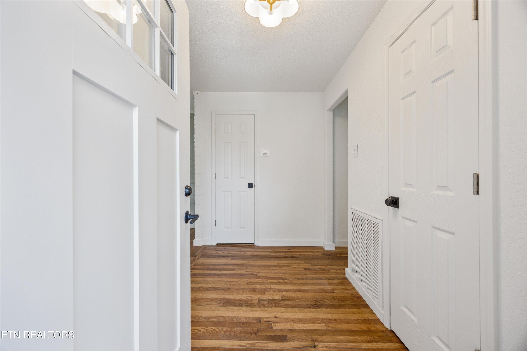 100 Pearl Road Oak Ridge, TN 37830 - Photo 6 of 37 a view of a hallway with wooden floor and entryway