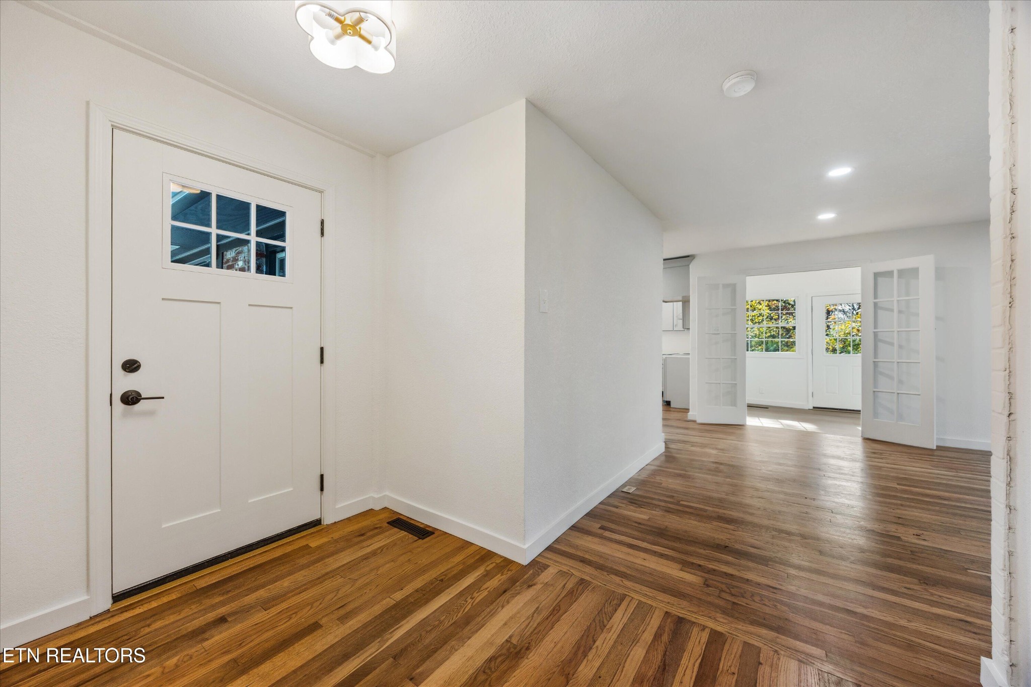 100 Pearl Road Oak Ridge, TN 37830 - Photo 10 of 37 a view of an empty room with wooden floor and a window
