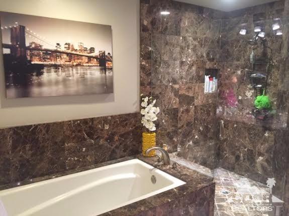 41310 Carlotta Drive Palm Desert, CA 92211 - Photo 15 of 32 a bathroom with a bathtub