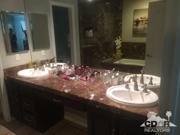 41310 Carlotta Drive Palm Desert, CA 92211 - Photo 16 of 32 a bathroom with a sink and a mirror