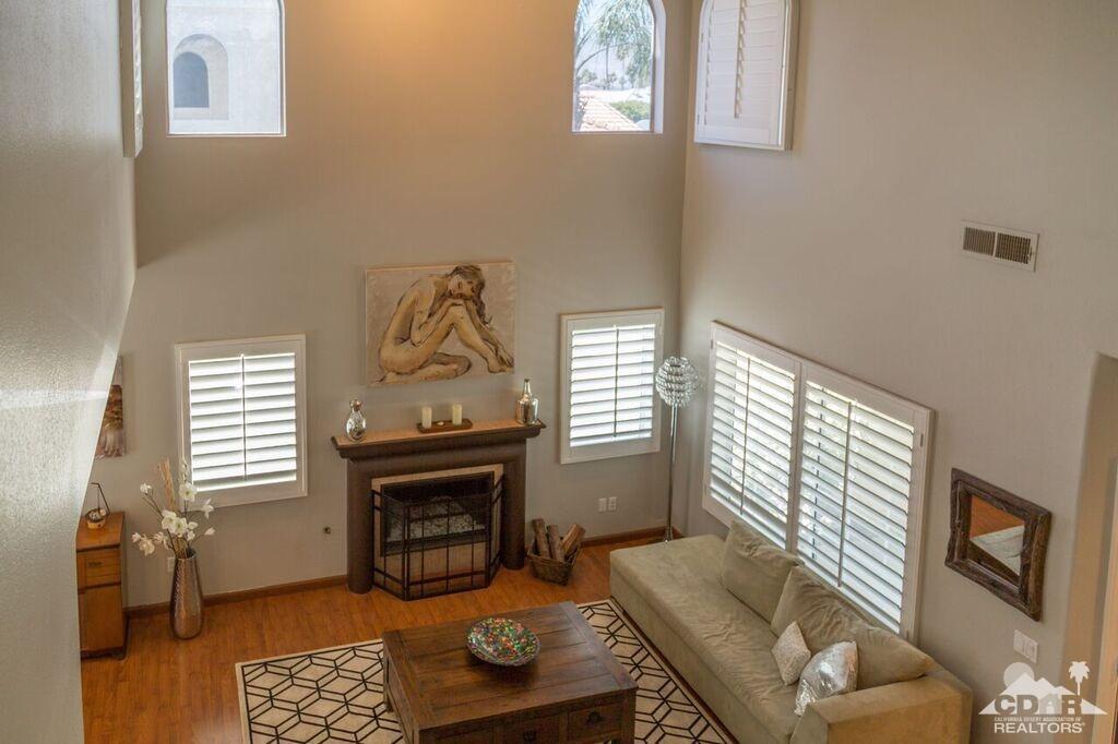 41310 Carlotta Drive Palm Desert, CA 92211 - Photo 18 of 32 a living room with furniture a fireplace and a window
