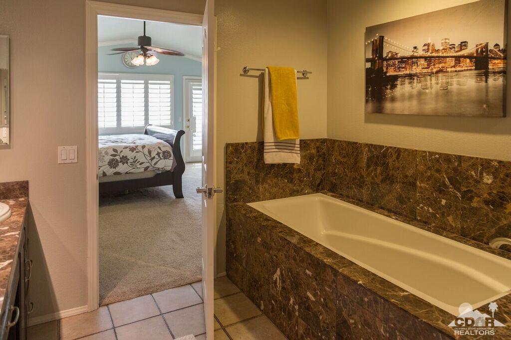 41310 Carlotta Drive Palm Desert, CA 92211 - Photo 22 of 32 a bathroom with a tub sink and mirror