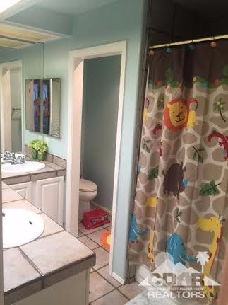 41310 Carlotta Drive Palm Desert, CA 92211 - Photo 25 of 32 a bathroom with a sink and a mirror
