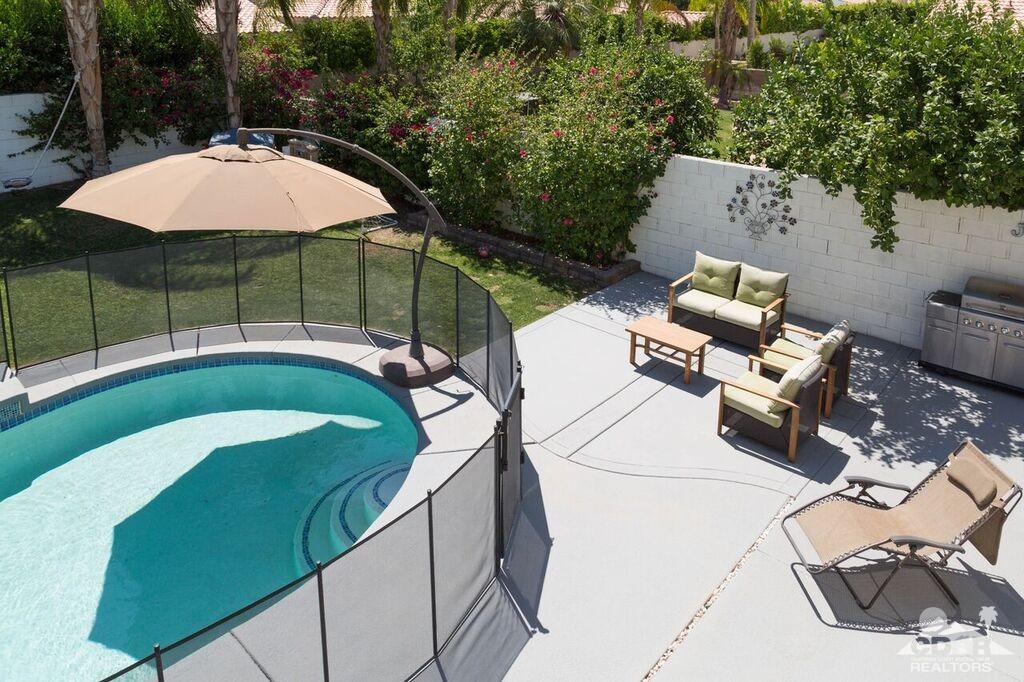 41310 Carlotta Drive Palm Desert, CA 92211 - Photo 27 of 32 a view of a swimming pool with a patio