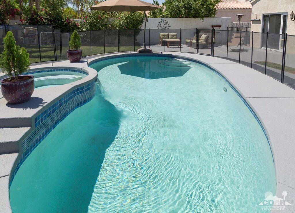 41310 Carlotta Drive Palm Desert, CA 92211 - Photo 32 of 32 a swimming pool with outdoor seating and yard