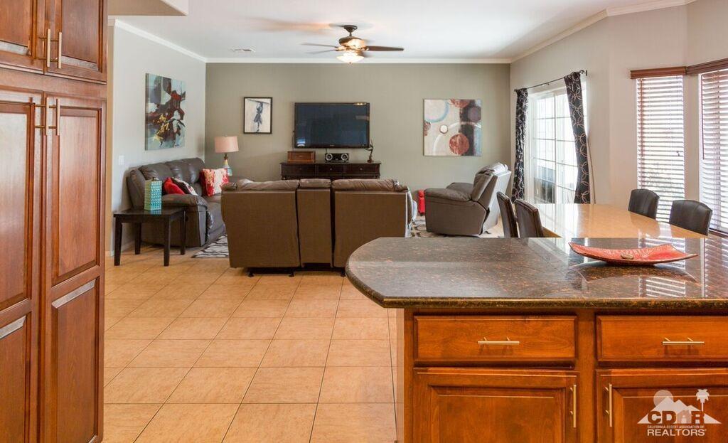 41310 Carlotta Drive Palm Desert, CA 92211 - Photo 4 of 32 a living room with furniture and a flat screen tv