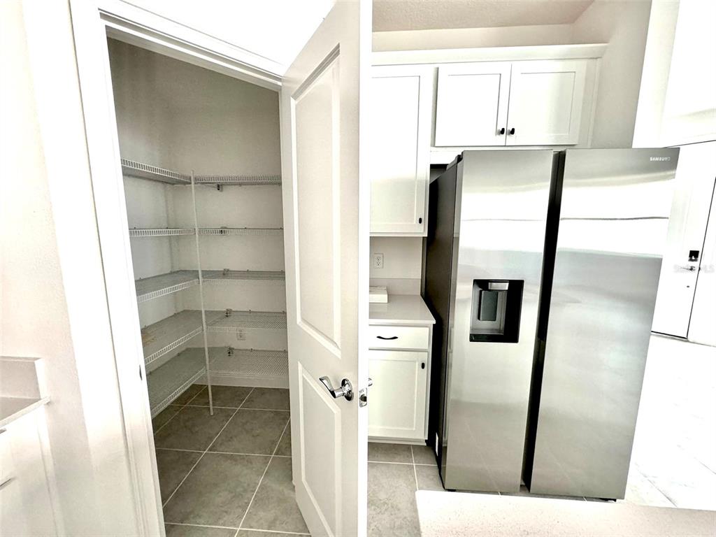 4826 Prairie Preserve Run St. Cloud, FL 34772 - Photo 11 of 44 a kitchen with stainless steel appliances a refrigerator and a sink