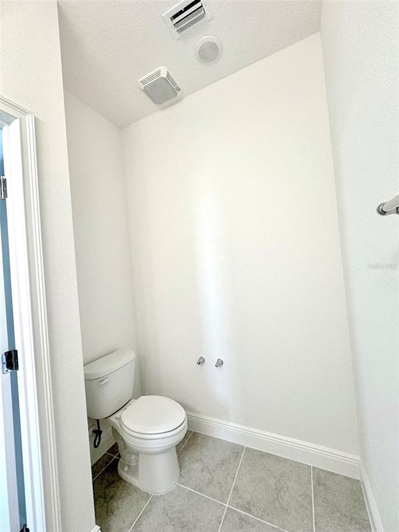 4826 Prairie Preserve Run St. Cloud, FL 34772 - Photo 14 of 44 a white toilet sitting next to a shower