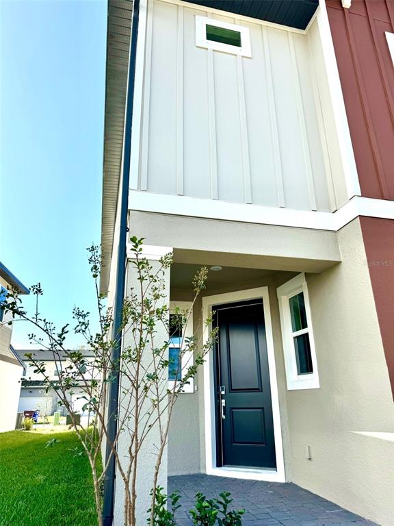 4826 Prairie Preserve Run St. Cloud, FL 34772 - Photo 2 of 44 a front view of a house with a garden