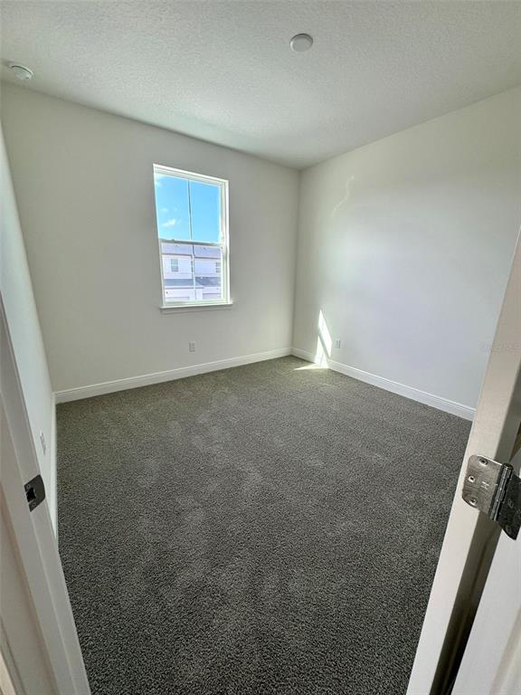 4826 Prairie Preserve Run St. Cloud, FL 34772 - Photo 26 of 44 an empty room with windows