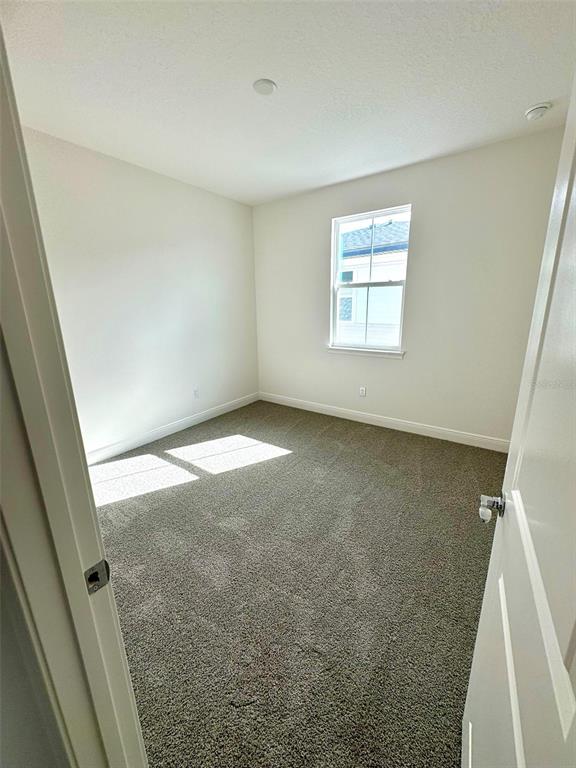 4826 Prairie Preserve Run St. Cloud, FL 34772 - Photo 27 of 44 an empty room with a windows