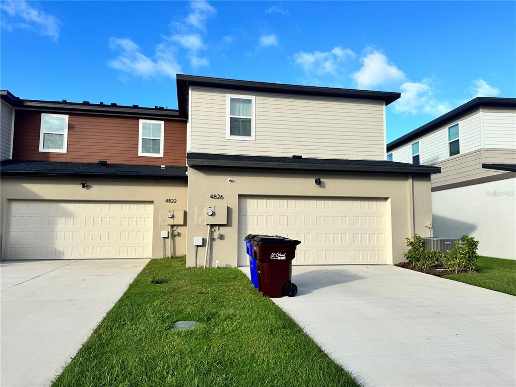 4826 Prairie Preserve Run St. Cloud, FL 34772 - Photo 36 of 44 a front view of a house with a yard and garage