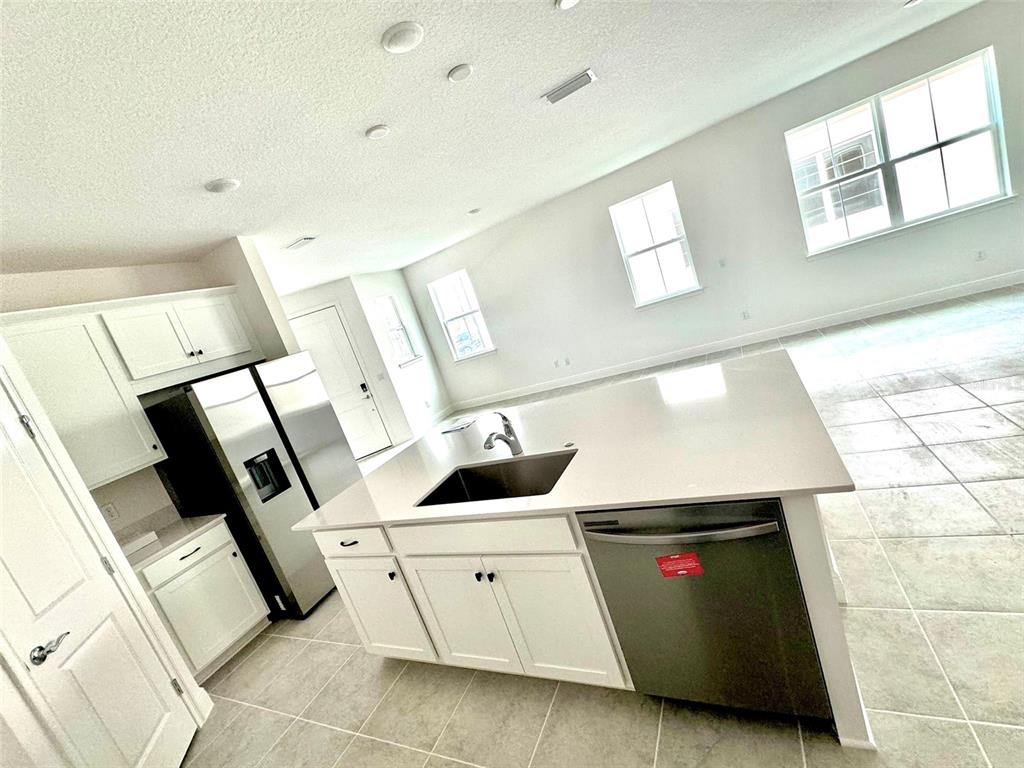 4826 Prairie Preserve Run St. Cloud, FL 34772 - Photo 9 of 44 a utility room with cabinets dryer and washer