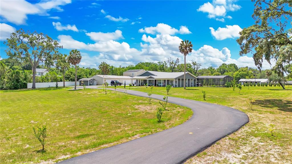 5785 Gilliam Road Orlando, FL 32818 - Photo 92 of 100 a view of a swimming pool with an outdoor space and seating area