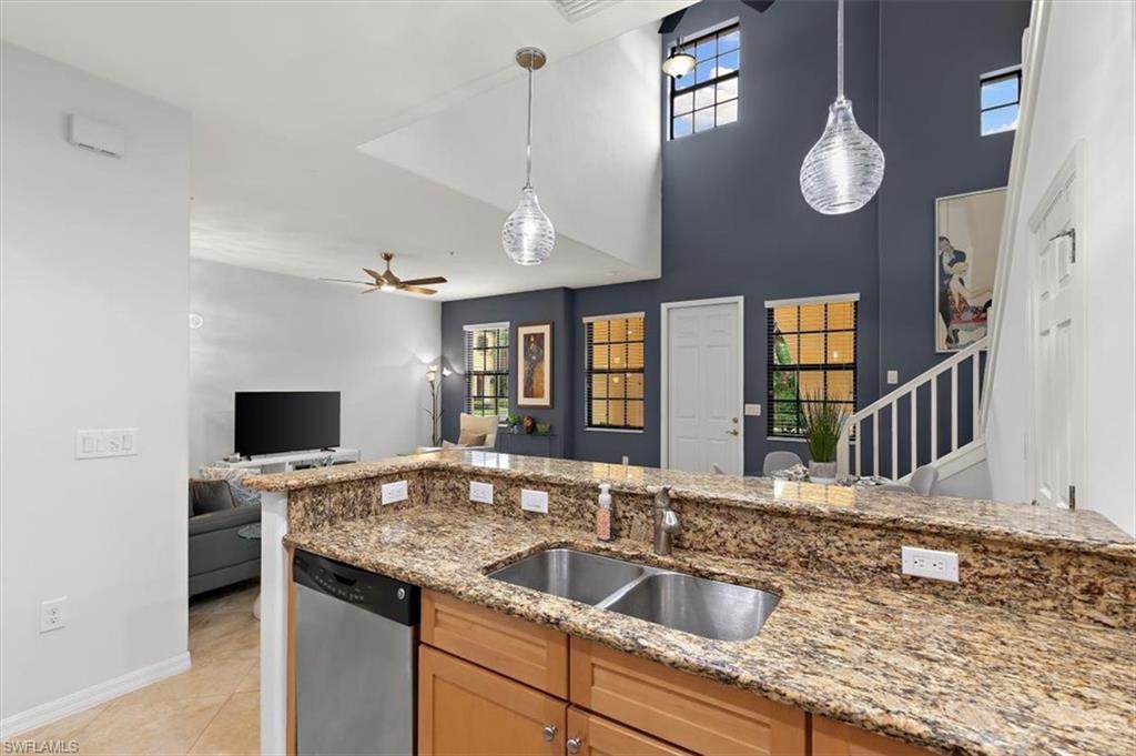 8985 Cambria Circle, Unit 211 Naples, FL 34113 - Photo 11 of 41 a kitchen with a sink appliances and a counter top space