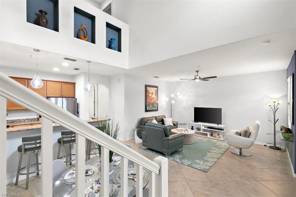 8985 Cambria Circle, Unit 211 Naples, FL 34113 - Photo 12 of 41 a living room with furniture and a flat screen tv