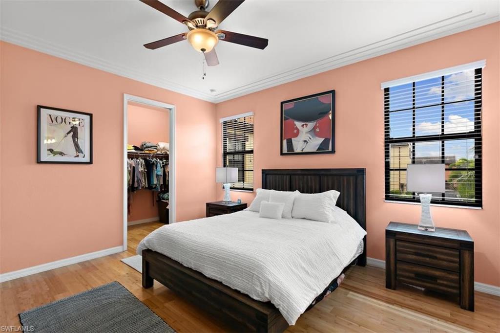 8985 Cambria Circle, Unit 211 Naples, FL 34113 - Photo 16 of 41 a bedroom with a large bed and a window