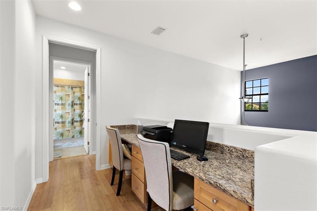 8985 Cambria Circle, Unit 211 Naples, FL 34113 - Photo 19 of 41 a view of workspace and kitchen with a window