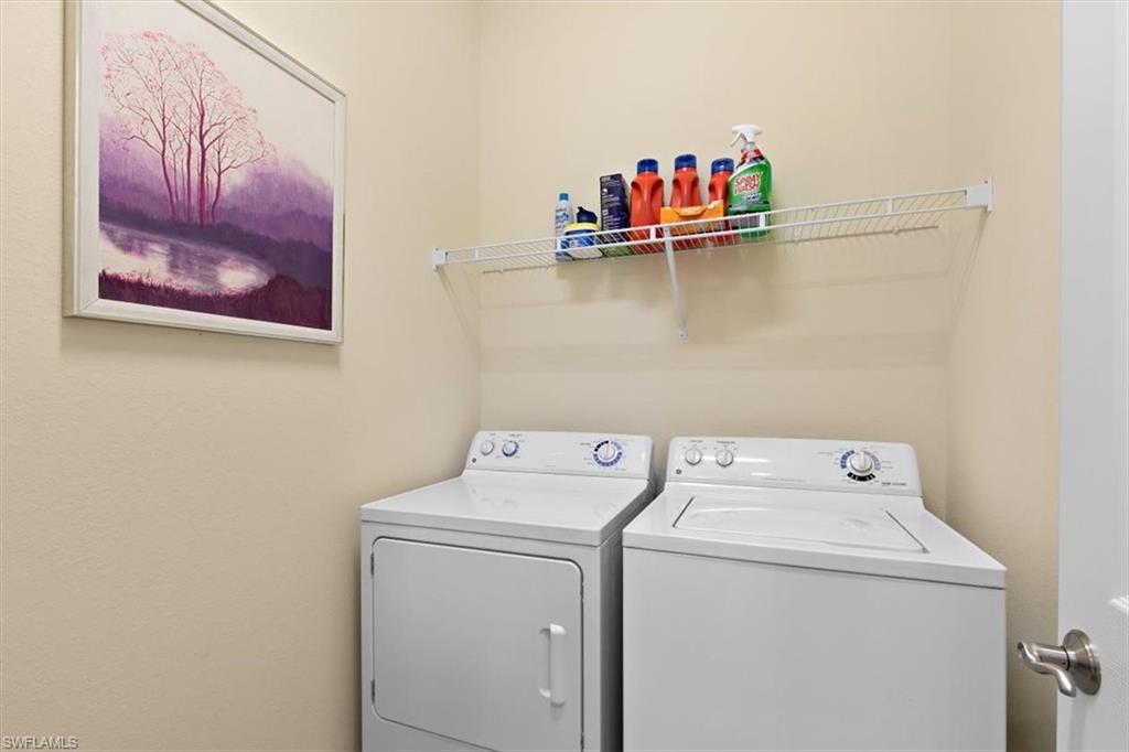 8985 Cambria Circle, Unit 211 Naples, FL 34113 - Photo 22 of 41 a utility room with dryer and washer