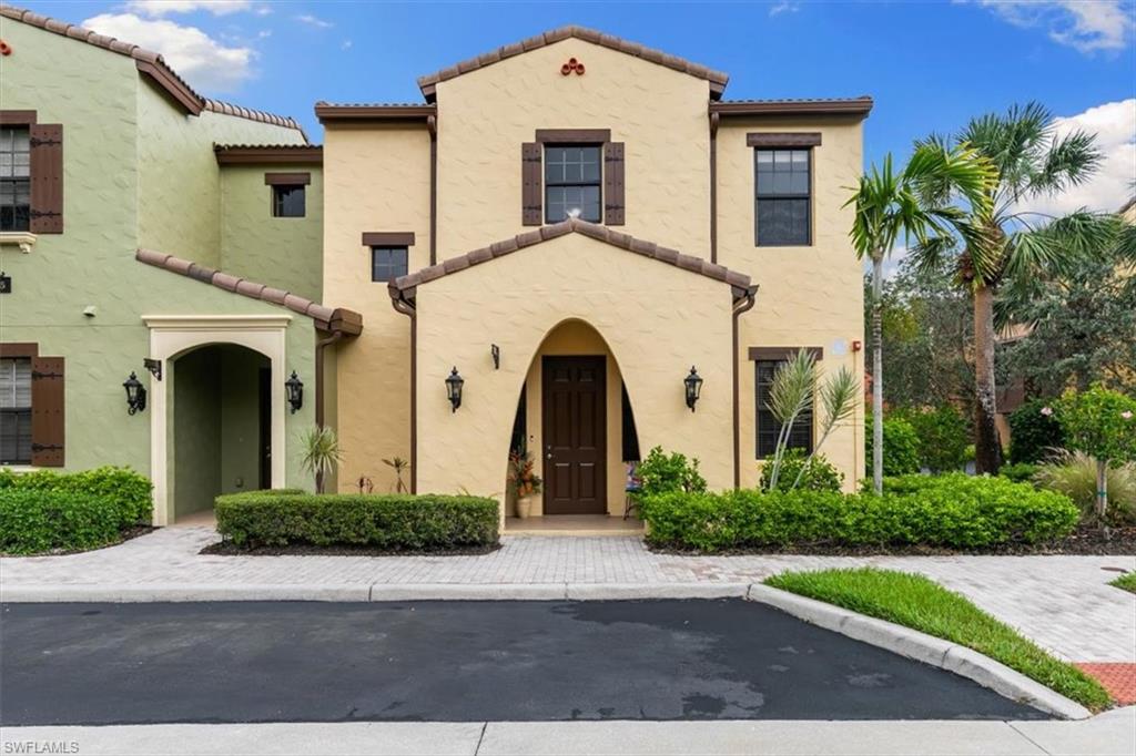 8985 Cambria Circle, Unit 211 Naples, FL 34113 - Photo 23 of 41 a front view of a house with garden
