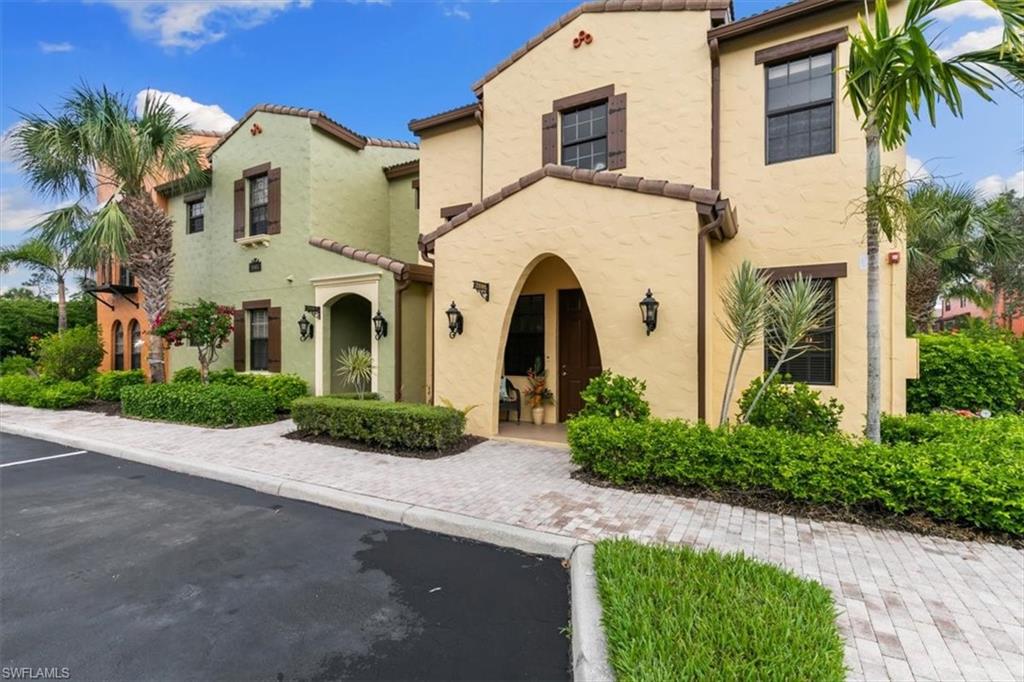 8985 Cambria Circle, Unit 211 Naples, FL 34113 - Photo 24 of 41 a front view of a house with a yard