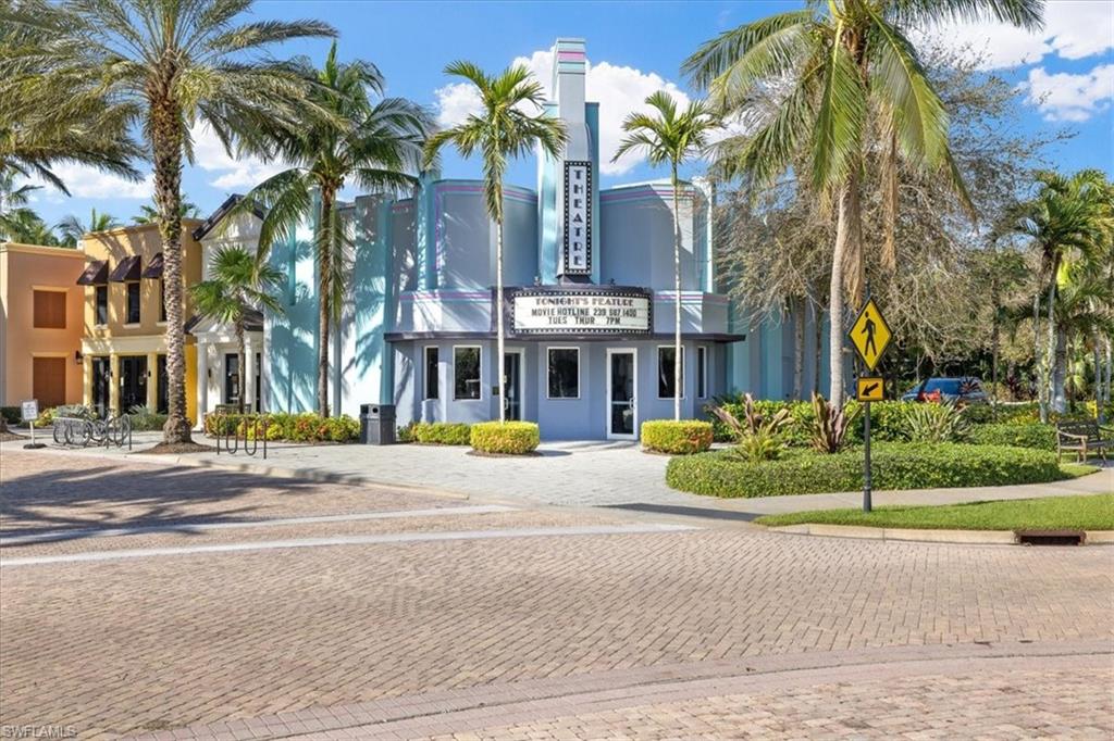 8985 Cambria Circle, Unit 211 Naples, FL 34113 - Photo 31 of 41 a front view of multi story residential apartment building with yard and sign board