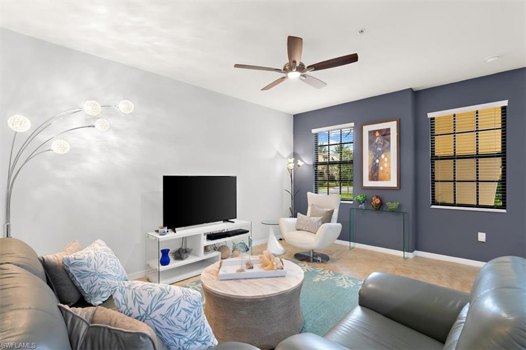 8985 Cambria Circle, Unit 211 Naples, FL 34113 - Photo 4 of 41 a living room with furniture and a flat screen tv