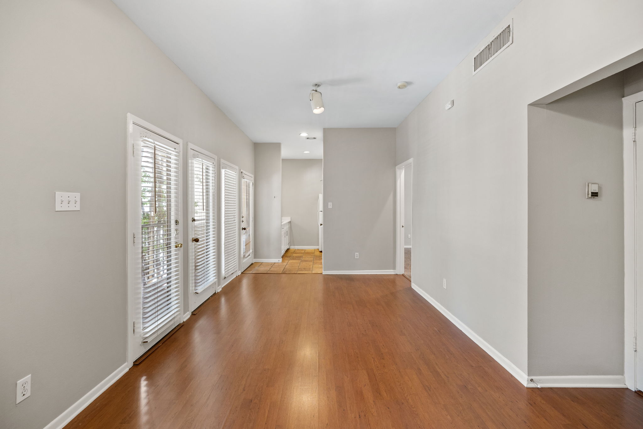 712 Graham Place, Unit 203 Austin, TX 78705 - Photo 27 of 30 a view of a hallway with wooden floor