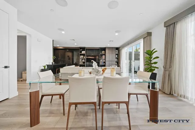 a living room with furniture and a book shelf
