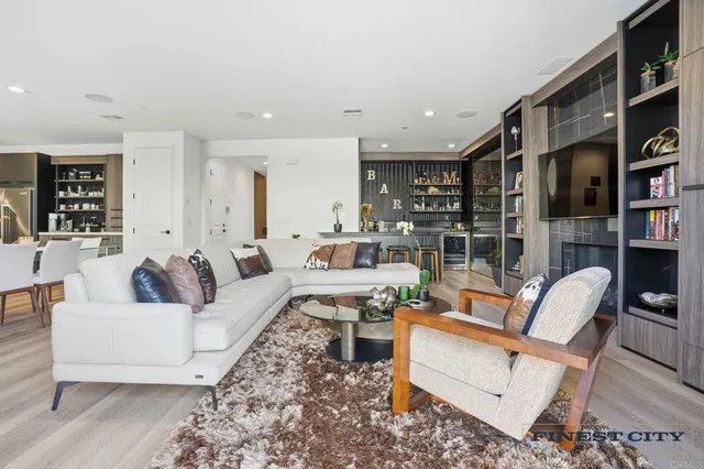 a living room with furniture and a wooden floor