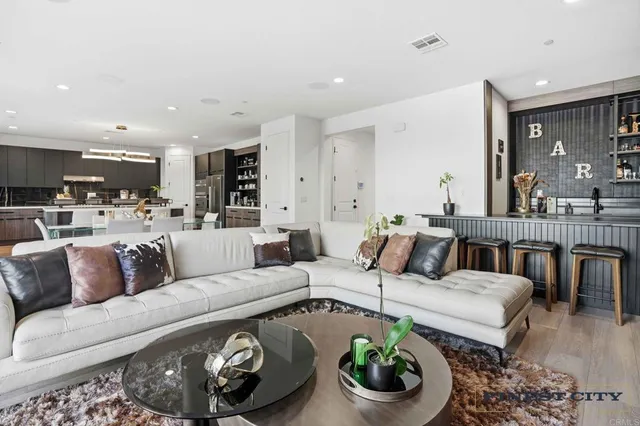 a bed sitting in a spacious bedroom next to a window