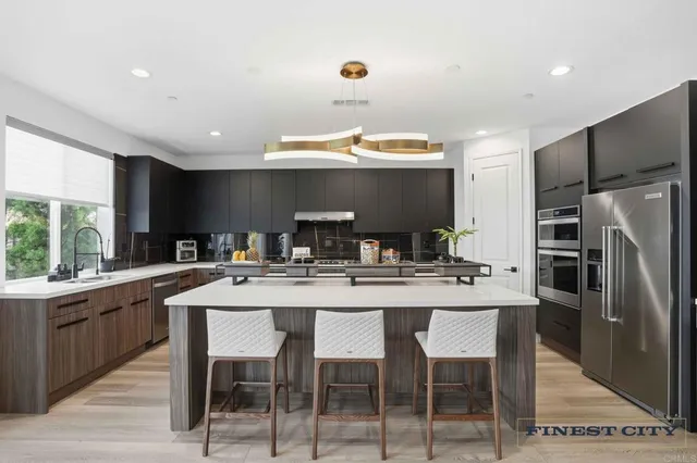 a kitchen with stainless steel appliances kitchen island granite countertop a sink counter space and cabinets