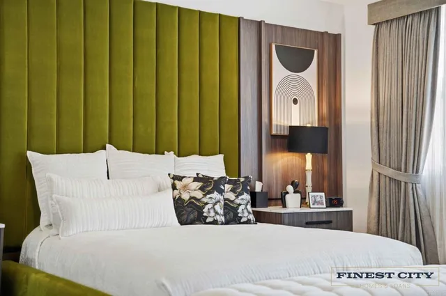 a view of a livingroom with wooden floor and a ceiling fan