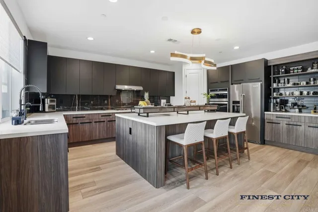 a kitchen with a dining table chairs and white cabinets