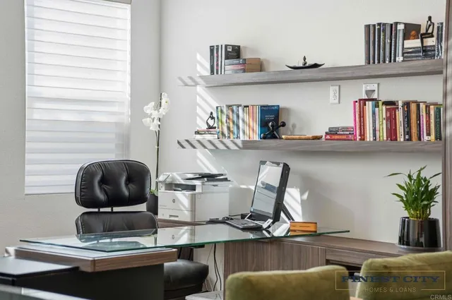 a view of a patio with table and chairs potted plants and floor to ceiling window