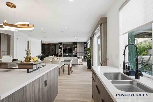 a kitchen with kitchen island a sink and a stove with wooden floor