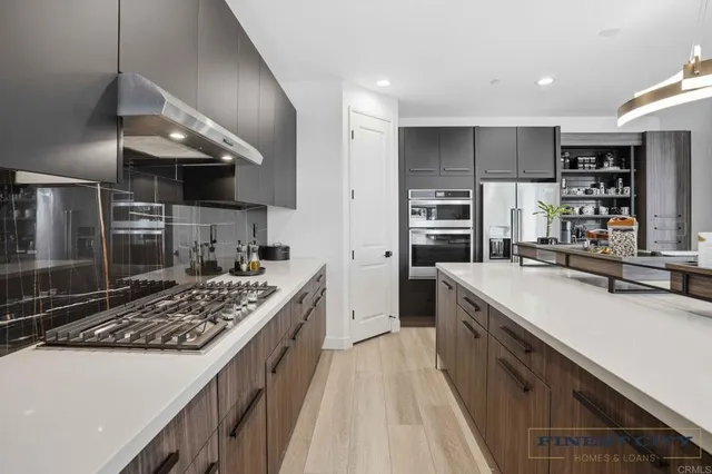 a kitchen with a sink a stove and chairs