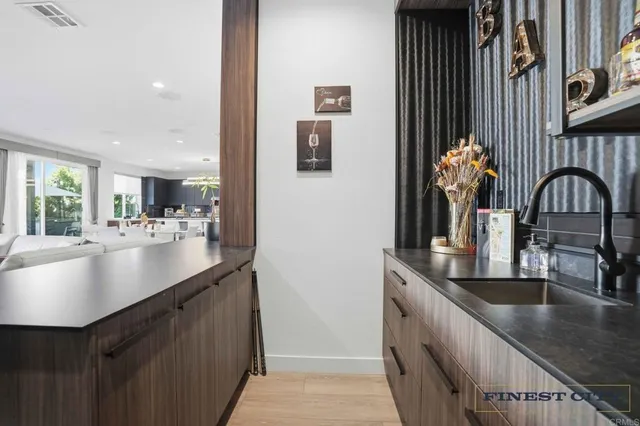 a kitchen with kitchen island a large window and a sink