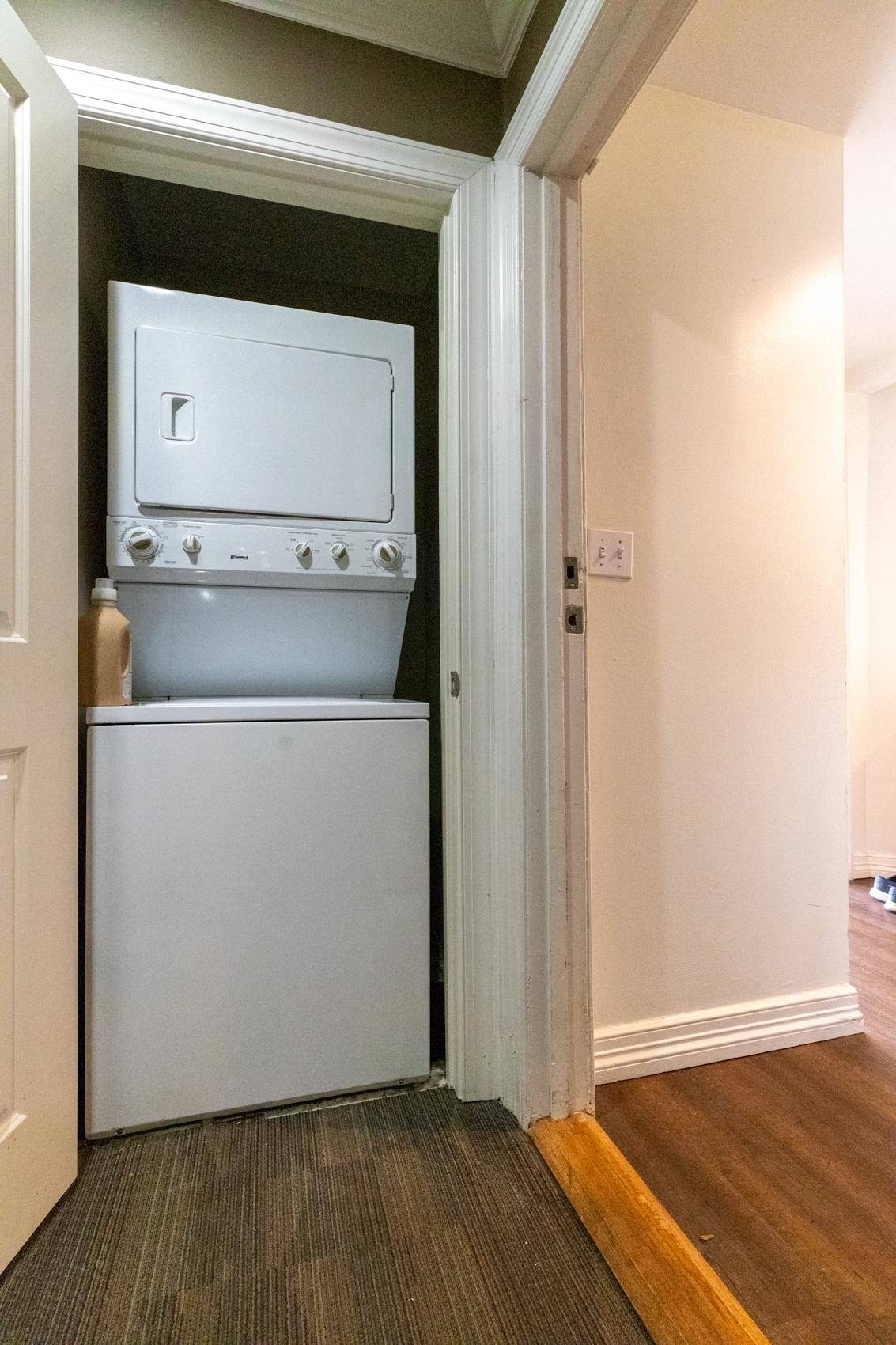 655 Riverside Drive, Unit 1008A Memphis, TN 38103 - Photo 3 of 10 Washroom with stacked washer and clothes dryer and baseboards
