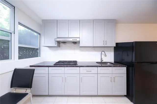 a kitchen with stainless steel appliances granite countertop a sink stove and cabinets